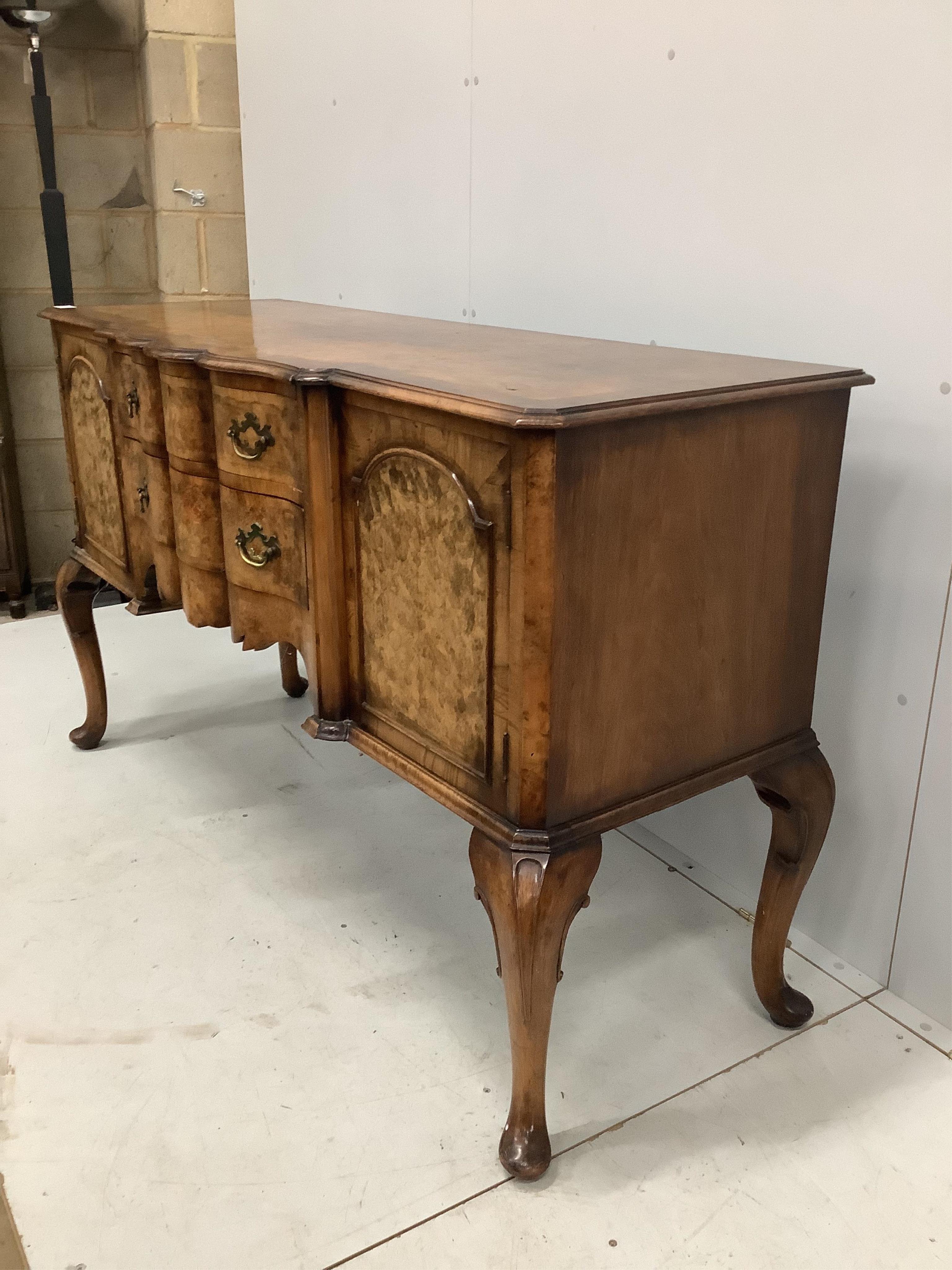 A Queen Anne Revival serpentine walnut sideboard, width 152cm, depth 59cm, height 93cm. Condition - fair